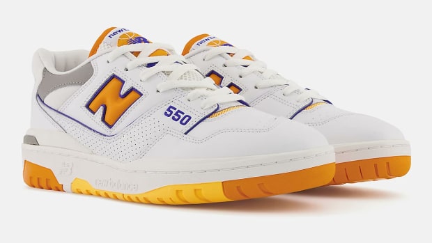 View of white, orange, purple New Balance 550 shoes.